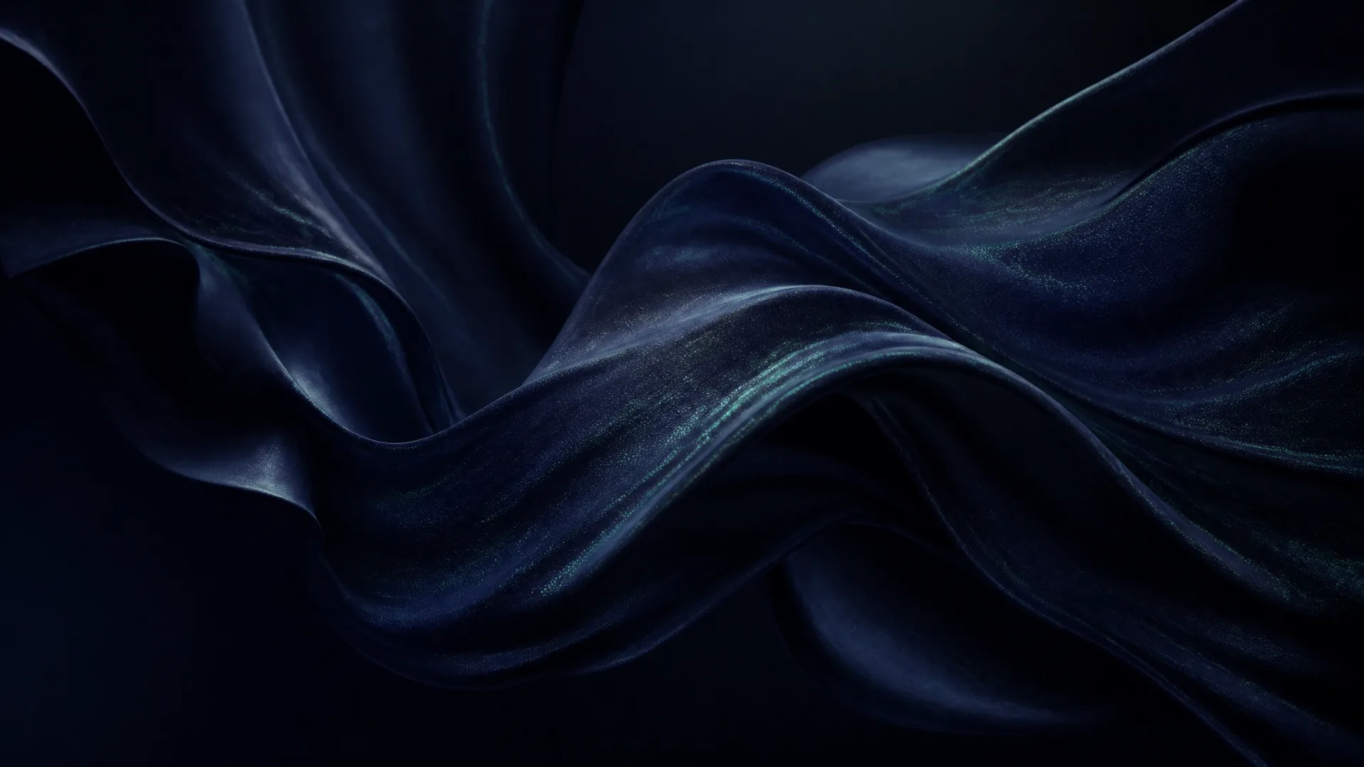 Dark silk in deep folds, lit along the crests with a faint green sheen.